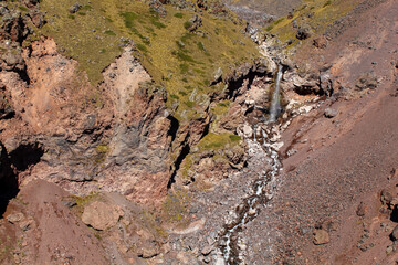 The volcanic soil around the mountains and the river waterfall.