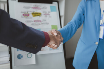 Two businessmen shake hands after a joint meeting, business venture handshake saluting, business meeting, presentation of business idea. The concept of joint venture investment by leaders.