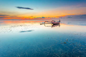 Morning sun in Bali, Indonesia. Traditional fishing boats at Sanur beach, Bali, Indonesia. - 664706851