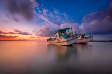 Morning sun in Bali, Indonesia. Traditional fishing boats at Sanur beach, Bali, Indonesia. - 664706870
