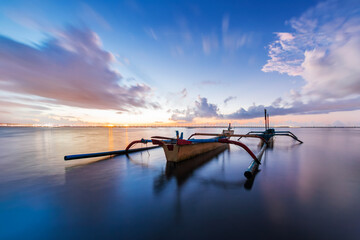 morning sun in Bali, Indonesia. Traditional fishing boats at Sanur beach, Bali, Indonesia. - 664706875
