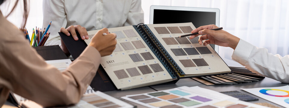 Group of interior designer team in meeting, discussing with engineer on interior design and planning for house project blueprint and model, choosing various mood board materials. Insight