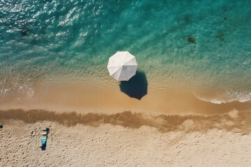 A sandy beach with an umbrella, captured from above. Generative AI