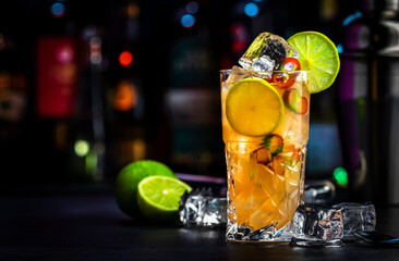 Siam sunrise trendy cocktail drink with vodka, coconut liqueur, ginger, chili pepper, soda, lime...