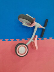 tricycle toddler training bike or infant walker scooter in the indoor playground.