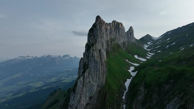 Ascending drone shot of Altmann Mountain with a man standing on Saxer Lucke Viewpoint, Switzerland