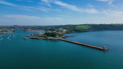 Aerial footage of the Mount Batten Peninsula on a sunny day in Plymouth Sound, Devon, England