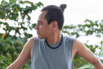 Portrait of a Man looking to the side surrounded by nature.