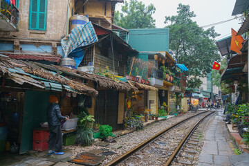 Hanoi train street, old house and railroad with Vietnamese flags on holiday in Hanoi, Vietnam