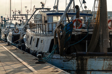 Fototapeta na wymiar Chalutiers amarrés dans un port de pêche au petit matin