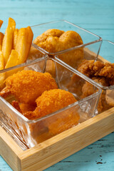 angle view french fries and deep fried shrimps and chicken nuggets and popcorn chicken vertical composition