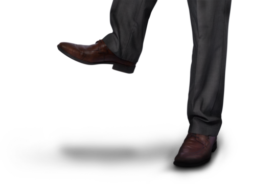 Digital png photo of legs of businessman walking on transparent background - Powered by Adobe