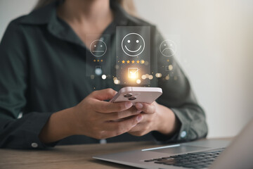 customer satisfaction survey concept businesswoman use smartphone Touch the happy smiley icon....