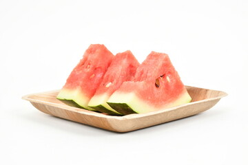 Watermelon fruit slices on tray. White background. Ripe juicy watermelon pieces. triangle of watermelon isolated on white. Real Images.