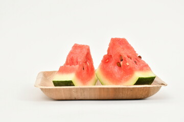 Watermelon fruit slices on tray. White background. Ripe juicy watermelon pieces. triangle of watermelon isolated on white. Real Images.