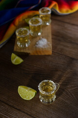 Tequila shots with salt and lime on a bar table. Shots of tequila and typical mexican elements.
