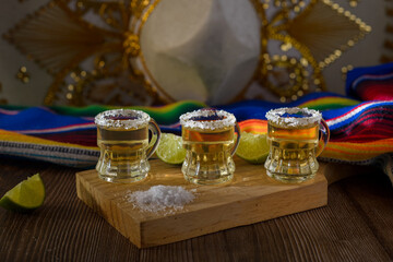 Tequila shots with salt and lime on a bar table. Shots of tequila and typical mexican elements.