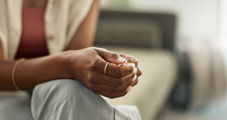Anxiety, hands and closeup of woman on a sofa with fear, worry or mental health crisis at home. Stress, zoom and female person in living room with conflict trauma, ptsd or disaster, mistake or abuse