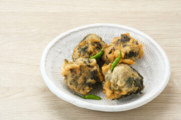 Rolade Tahu, cassava leaves with tofu crumbs fried in flour. Indonesian snack
