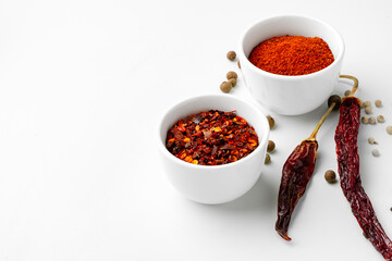 Various spices in a bowls on white background