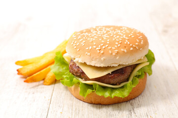 Tasty burger with beef and cheese, french fries