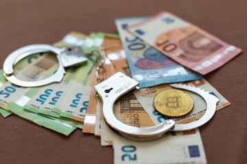 Turkish lira banknotes, US Dollars, Euro and bitcoin coin Euro handcuffs
