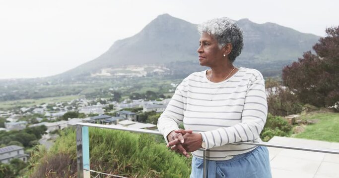 Smiling senior african american woman on balcony, copy space, slow motion