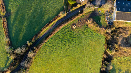 Top down view of Cornwall farm fields with barn and road running through them