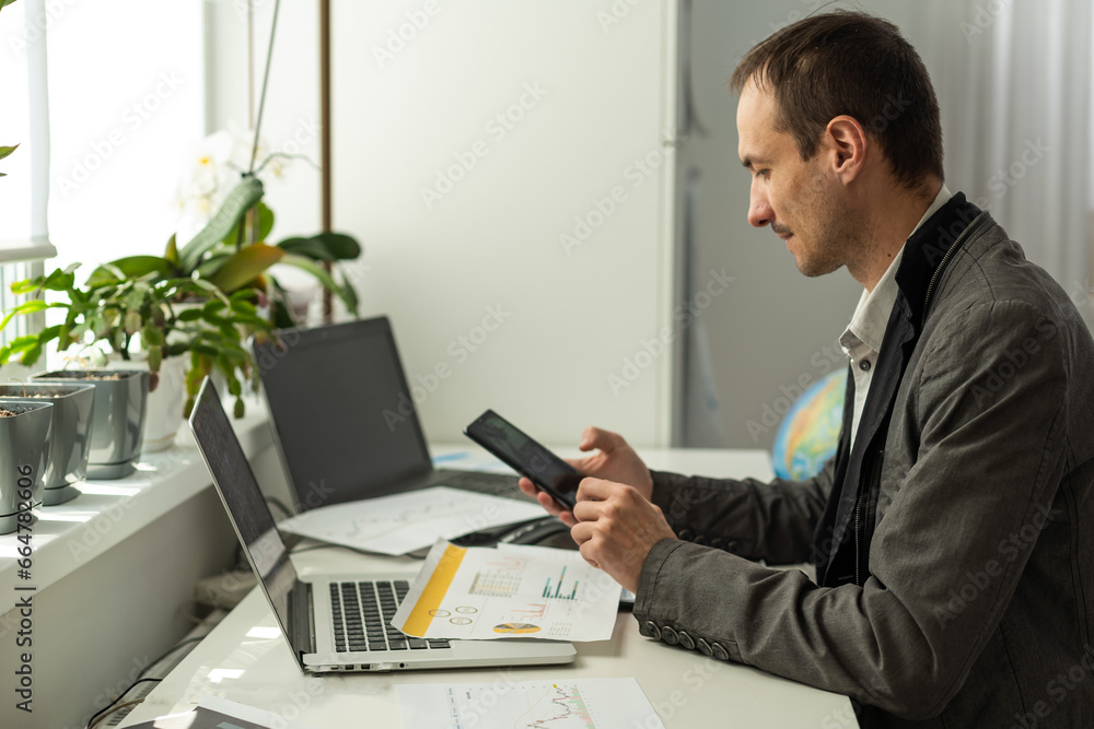 Aufkleber trading stocks online. back view of young businessman or trader working with graph and charts on com