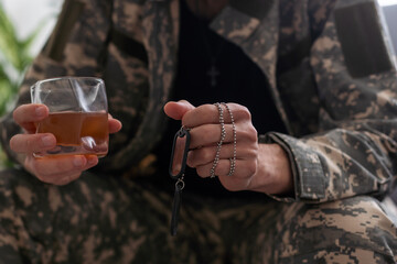 A man in camouflage suffers from depression after returning from the army. He drinks alcohol in the basement. He is tormented by heavy memories.