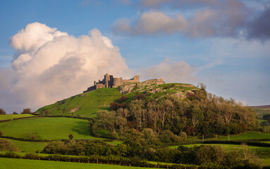 The dramatic castle ruins of Carrag Cennen located on top of a rocky hill in the Carmarthenshire countryside Wales UK