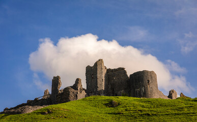 The dramatic castle ruins of Carrag Cennen located on top of a rocky hill in the Carmarthenshire countryside Wales UK