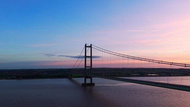 Sunset's silhouette: Humber Bridge takes center stage as cars paint a tranquil picture in an aerial drone's view.