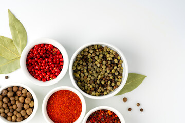 Various spices in a bowls on white background