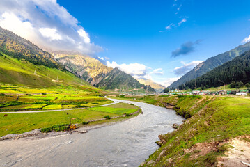 A stunning view of mountain, river, valley, snow, blue sky, white clouds. A serene place at national highway at the Himalayan mountain range