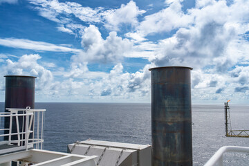 Smoke stacks from offshore gas and oil drilling rigs in the petroleum industry.