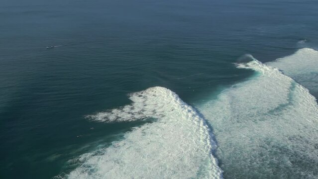 Aerial view of large white surf waves on the sea