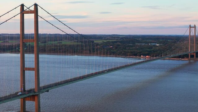 Sunset's embrace: Aerial view of Humber Bridge, cars crossing gently.