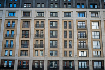 Fragment of the facade of a multi-storey residential building on an autumn day