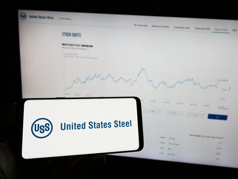 Stuttgart, Germany - 09-25-2023: Person holding cellphone with logo of company United States Steel Corporation (US Steel) in front of business webpage. Focus on phone display.