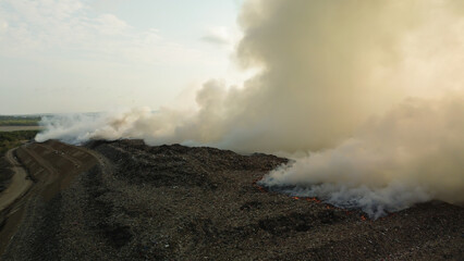 Flying a drone over a fire that occurred at a landfill on the island of Bali. Plastic waste is burning, a real environmental disaster. Garbage recycling and waste disposal.