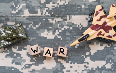 The word war in block letter laying on the floor next to dog tags
