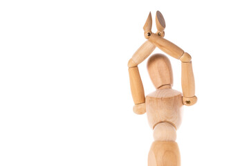 A wooden mannequin is depicted holding a pair of scissors. This image can be used to represent creativity, fashion design, or the art of tailoring.