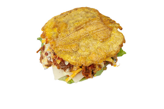 patac&oacute;n or toston fried green plantain with shredded meat and tomato sauce