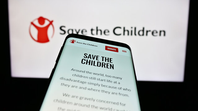 Stuttgart, Germany - 10-06-2023: Smartphone with website of charity organization Save the Children Fund in front of logo. Focus on top-left of phone display.