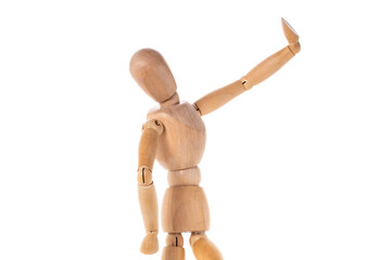 A wooden mannequin standing on a white surface. This picture can be used for various creative projects and design purposes.