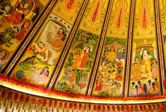 A vibrant and intricately designed Durga Puja pandal in Kolkata, showcasing the grandeur of traditional Bengali artistry. The pandal is adorned with elaborate decorations and houses the majestic idol 