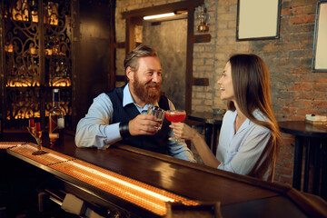 Man and woman rest together in bar talking