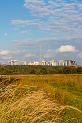 View of urban development from a distance in a field