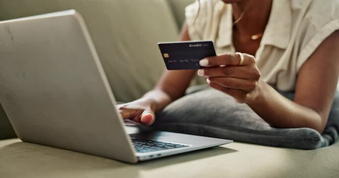 Closeup, hand and laptop with credit card for payment by typing on website for online shopping. Female, consumer and fintech for e commerce, digital banking or electronic purchase from home on sofa
